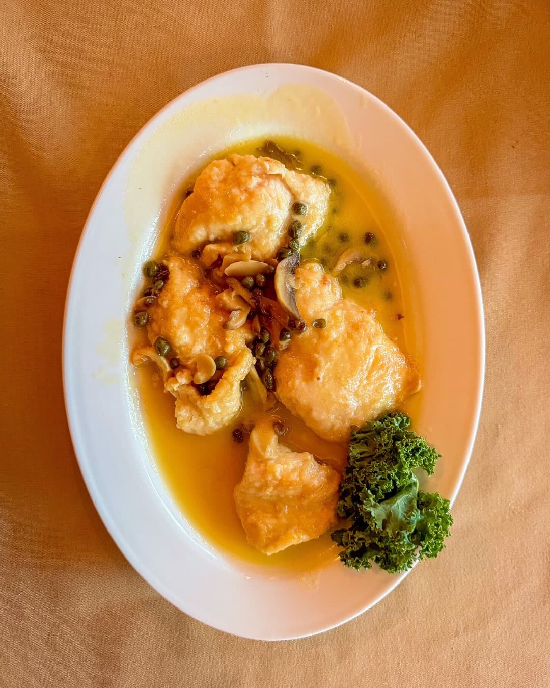 Chicken finished in a lemon, white wine and caper sauce with mushrooms