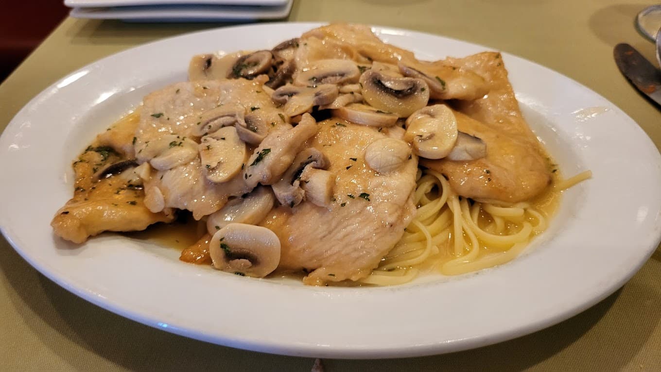 Chicken ala Marsala — tender cutlets with mushrooms in marsala wine sauce over linguine