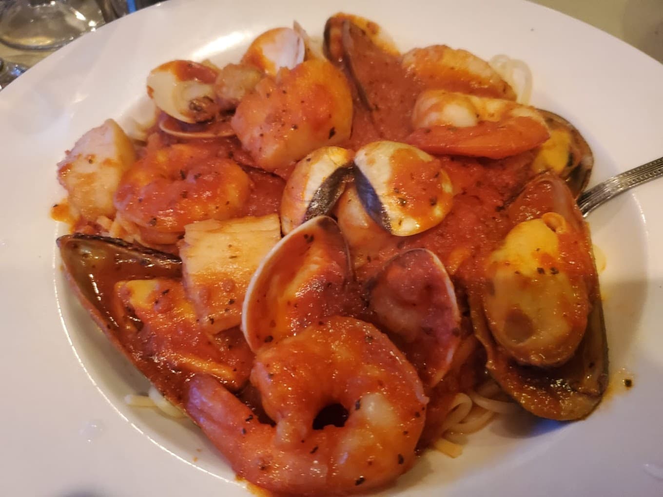 Seafood Fra Diavolo — shrimp, scallops, clams and mussels in spicy red sauce over linguine
