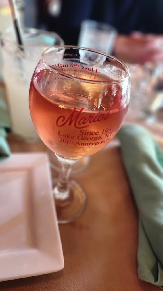 A glass of Mario's rosé in an etched 70th-anniversary wine glass